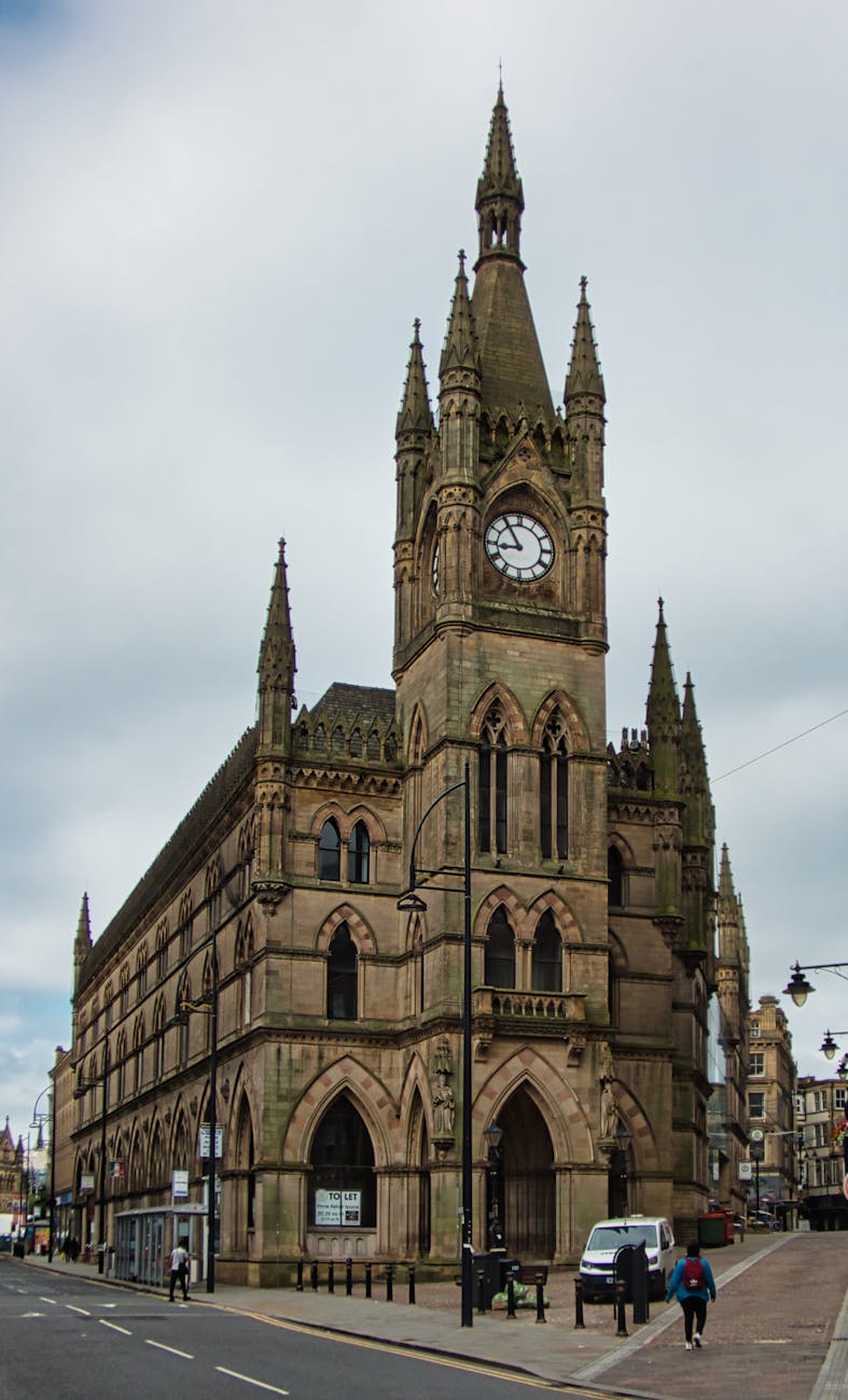 a brown concrete building under the white clouds